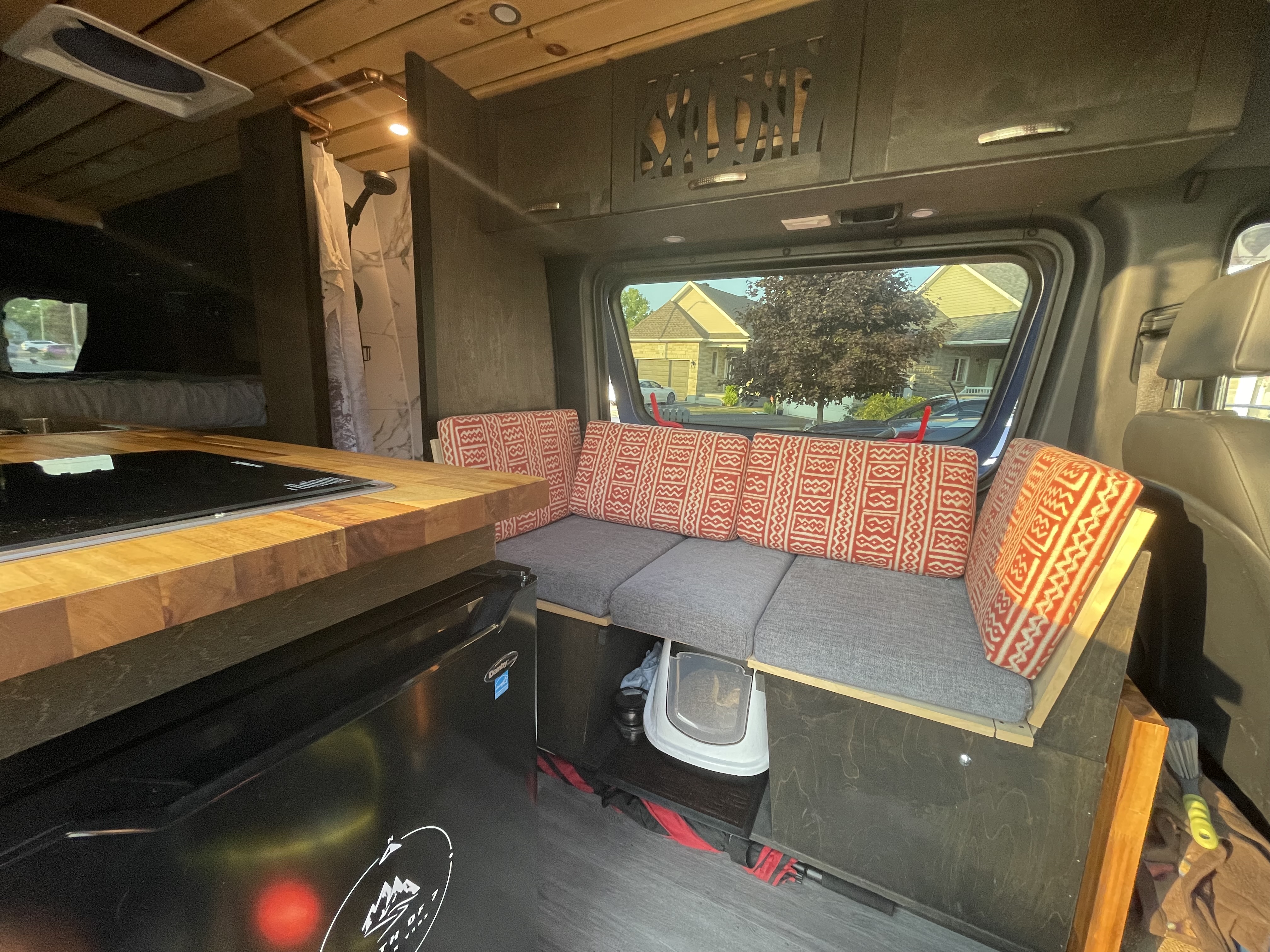 Our little couch has had a small makeover with different fabric and added back cushions (Momo, our cat, has his litter box safely stowed for travel)